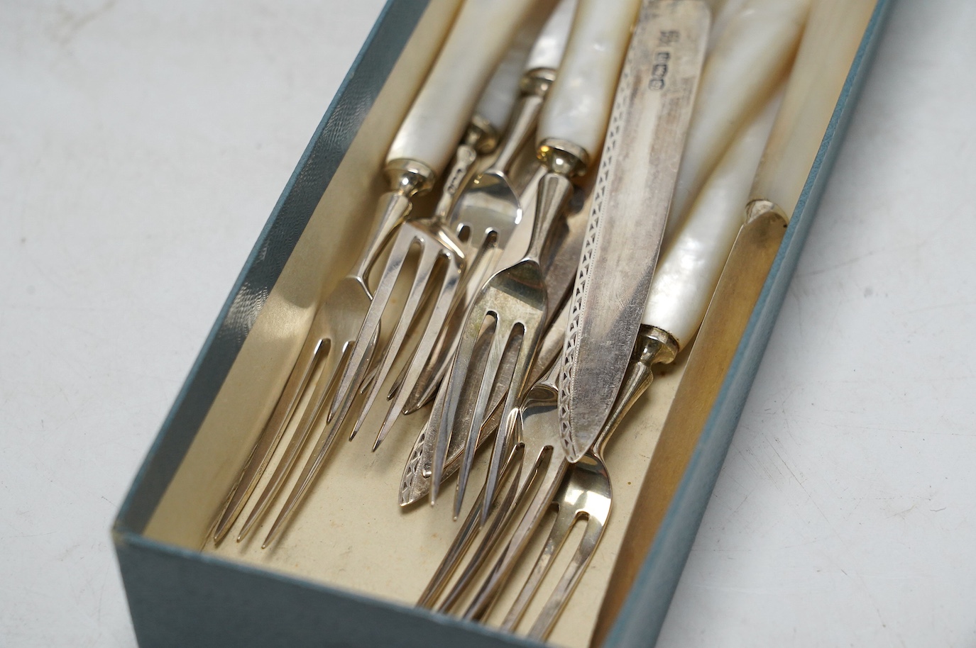 Six pairs of George V mother of pearl handled silver dessert eaters, Frederick C. Asman & Co, Sheffield, 1925, knife 18.9cm. Condition - fair to good